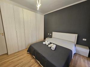 a bedroom with a bed with two towels on it at New Bazar-Central Apartment 1 with balcony in Tirana
