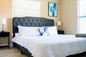 a bedroom with a large bed with a blue headboard at Highland Heights in Tampa