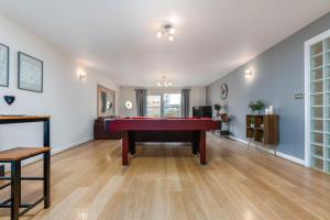 a living room with a pool table in it at Cozy 2BR Retreat | Prime Cardiff Location in Cardiff