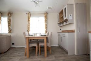 a kitchen and dining room with a table and chairs at Skegness Holidays in Skegness