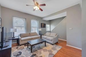 a living room with two couches and a ceiling fan at 2 Units Side-By-Side Sleeps 24 in Tower Grove