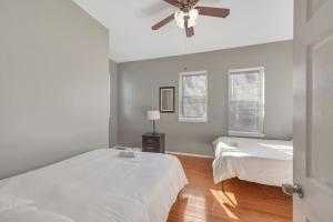 a bedroom with two beds and a ceiling fan at 2 Units Side-By-Side Sleeps 24 in Tower Grove
