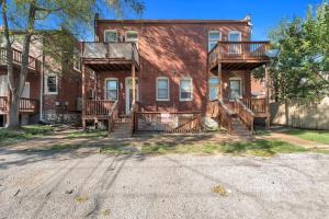 a red brick house with wooden balconies on it at 2 Units Side-By-Side Sleeps 24 in Tower Grove