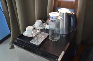 a table with a blender and cups on it at ALU Hotel Davao in Davao City