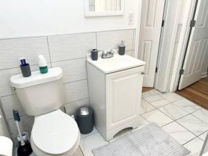 a white bathroom with a toilet and a sink at Full Suite with Hot Tub Wifi Room 4 in Atlanta