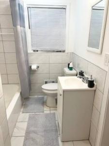 a white bathroom with a sink and a toilet at Full Suite with Hot Tub Wifi Room 4 in Atlanta