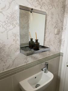 a bathroom with a sink and a mirror at Floyter House North Yorkshire Moors National Park in Danby