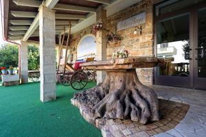 a tree stump table in front of a building at Antico Borgo Marchese in Morciano di Leuca