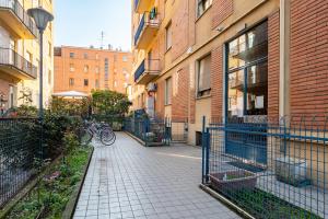 an alley with a bike parked next to a building at Oltretorrente Ospedale Apartment in Parma