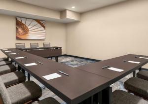 a conference room with tables and chairs and a wall at Fairfield Inn Scranton in Scranton