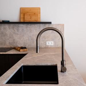 a kitchen sink with a faucet on a counter at Romantic getaway with terrace in Ghent in Ghent