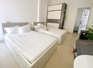 a bedroom with two beds and a mirror at SAIGONESE Studio in Ho Chi Minh City