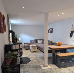 a living room with a couch and a table at Storchennest in Neuried