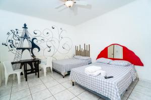 Een bed of bedden in een kamer bij hotel trinidad