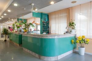 a green counter in a room with plants at HOTEL AZZURRA in Senigallia