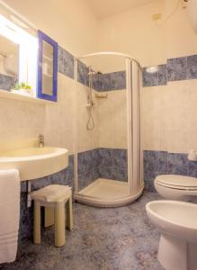a bathroom with a shower and a toilet and a sink at HOTEL AZZURRA in Senigallia