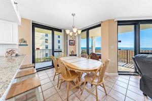 a dining room with a table and chairs at Phoenix 6 Unit 215 in Orange Beach