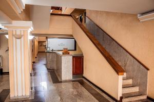 a hallway with a staircase in a building at Sakr Hotel in Penápolis