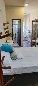 sypialnia z dużym białym łóżkiem z niebieskimi poduszkami w obiekcie Flat 131 - Point do Canto w mieście Rio Acima