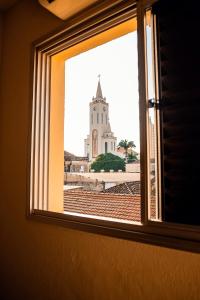 a view of a church from a window at Sakr Hotel in Penápolis