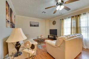 a living room with a couch and a ceiling fan at Cozy Lake Charles Apartment 2 Mi to Downtown in Lake Charles