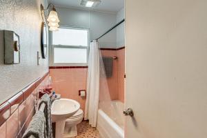 a bathroom with a sink and a toilet and a tub at Matewan Vacation Rental Near Devil Anse Trail! 