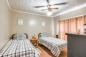 a bedroom with two beds and a ceiling fan at Matewan Vacation Rental Near Devil Anse Trail! 