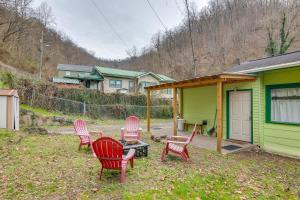 a group of chairs and a table in front of a house at Matewan Vacation Rental Near Devil Anse Trail! 