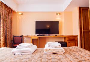 Uma TV ou centro de entretenimento em Hotel Villa Brescia