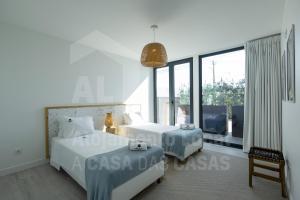 Postel nebo postele na pokoji v ubytování Bluevillas Ribamar T1 by ACasaDasCasas - Apartment 2