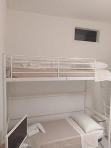 a white bunk bed with a computer in a room at Alle Porte Del Pigno House in Catania