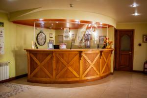 a large wooden bar in a room with a clock at Hotel Villa Brescia in Ushuaia