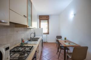 a kitchen with a sink and a stove top oven at Bologna41 in Parma