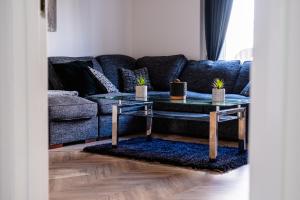 a living room with a couch and a table at Urban City Stay - SJA Stays - Luxury 2 Bed Apartment in Aberdeen