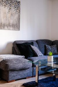 uma sala de estar com um sofá e uma mesa de vidro em Urban City Stay - SJA Stays - Luxury 2 Bed Apartment em Aberdeen