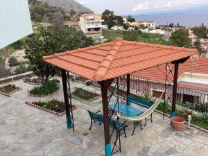 einen Pavillon mit einer Hängematte und einer Schaukel in der Unterkunft Depys' View in Chios