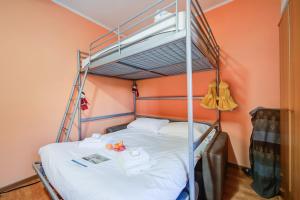 a bedroom with a bunk bed with white sheets at Studio Borgata Ski In Ski Out 300m - Happy Rentals in Sestriere