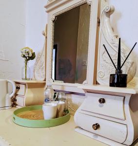 a cabinet with a mirror and a plate on a table at The Bay Horse Hotel Wolsingham in Wolsingham