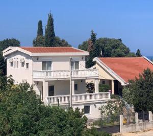 a large white house on top of a hill at Adriatic Family House in Utjeha