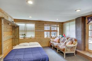 a bedroom with a bed and a couch and windows at Pet-Friendly Lakehouse View Tower and Fire Pit! in Lake Murray Shores