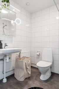 a white bathroom with a toilet and a sink at Consultant's Luleå Hub: Work & Rest in Luleå