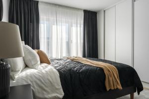 a bedroom with a bed and a large window at Consultant's Luleå Hub: Work & Rest in Luleå