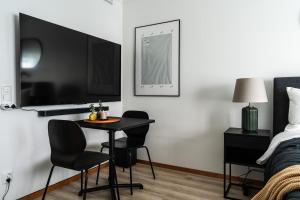 a bedroom with a table and chairs and a bed at Consultant's Luleå Hub: Work & Rest in Luleå