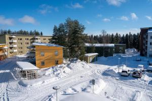 a city covered in snow with buildings and cars at Consultant's Luleå Hub: Work & Rest in Luleå