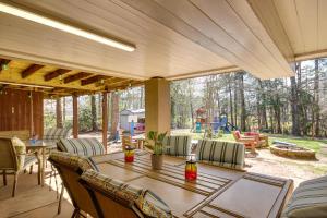 a patio with a table and chairs and a yard at Pet-Friendly Lakehouse View Tower and Fire Pit! in Lake Murray Shores