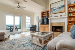 a living room with a fireplace and a tv at CR Escape in Dauphin Island