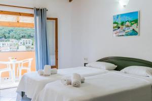 two beds in a room with a view at Porto Kassiopi Apartments in Kassiopi