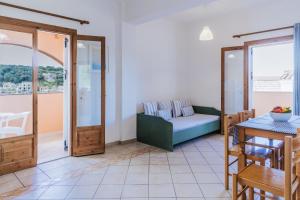 a living room with a couch and a table at Porto Kassiopi Apartments in Kassiopi