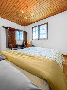 1 cama amarilla grande en una habitación con 2 ventanas en Plage et Forêt à La Barre-de-Monts, en La Barre-de-Monts