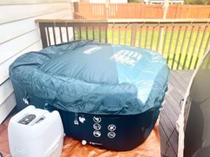 a blue ottoman sitting on top of a deck at Queen Suite - Hot Tub - Wifi Room 2 in Forest Park